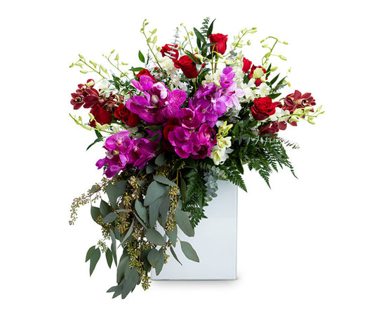 Small White Rectangular Vase with Orchids, Roses and Cascading Greenery